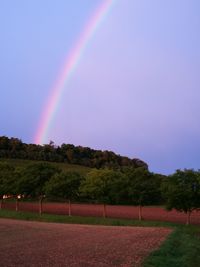 Rainbow over landscape against sky