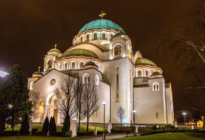 Low angle view of illuminated building against sky at night