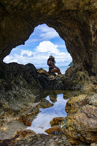 Woman sitting on rock