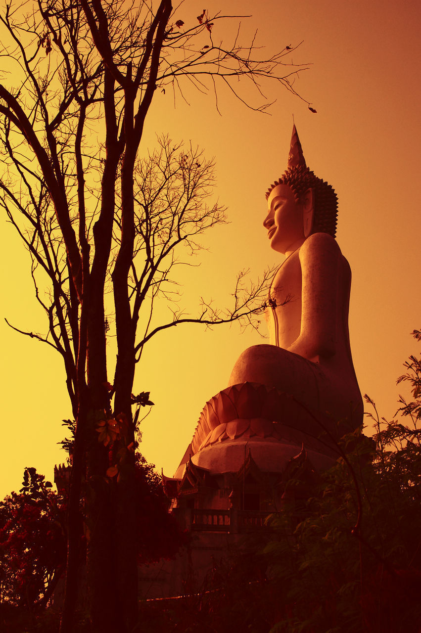 LOW ANGLE VIEW OF BUDDHA STATUE AGAINST SKY