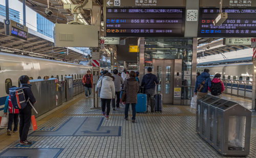 People walking on railroad station platform