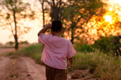 Rear view of a woman standing on land