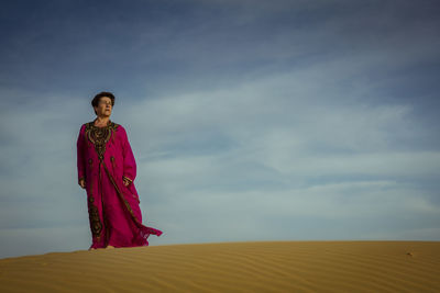 Portrait of woman standing against the sky