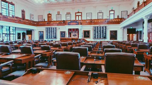 Empty chairs and tables in row
