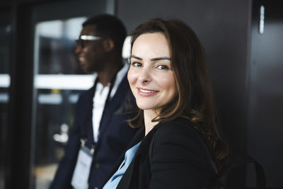 Side view portrait of businesswoman smiling at seminar