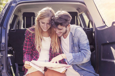 Portrait of young woman sitting in car