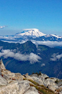 Scenic view of snowcapped mountains against blue sky