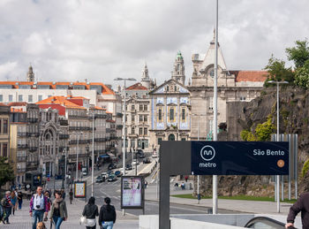 City street by buildings against sky