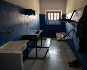 Empty chairs and table against wall at home