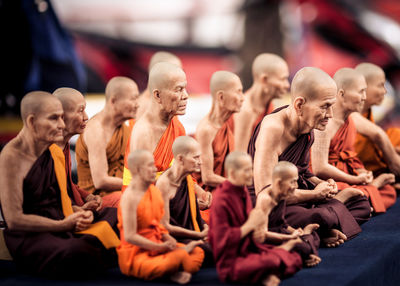 Digital composite image of monks sitting