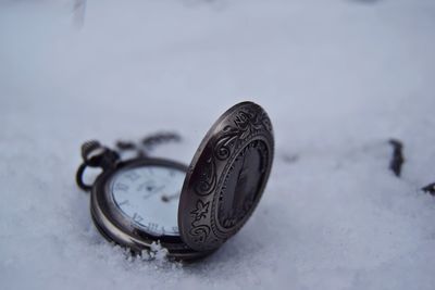 Close-up of clock on snow