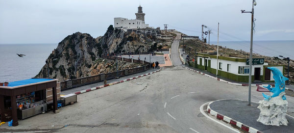 High angle view of townscape by sea against sky