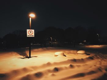 Illuminated information sign in winter at night