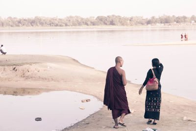 Full length of woman standing on shore