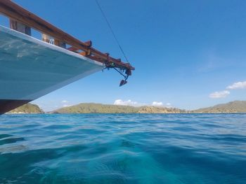 Sailboat in sea against blue sky