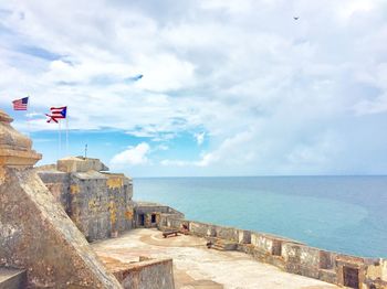 Scenic view of sea by fort against sky