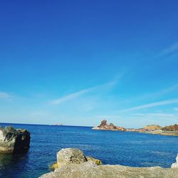 Scenic view of sea against blue sky