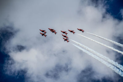 Low angle view of airshow against sky