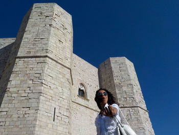 Portrait of woman against historic building