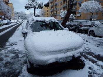 Snow covered street in city during winter