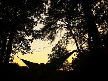 Low angle view of silhouette trees against sky at sunset