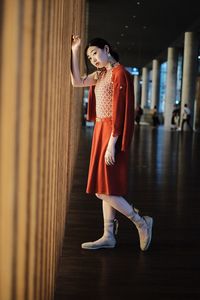 Woman looking away while standing on floor