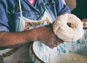 Midsection of woman preparing dough