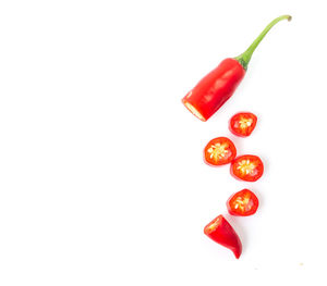 Close-up of red chili over white background