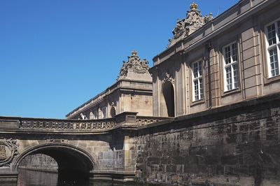 Low angle view of historical building against blue sky