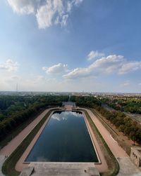 High angle view of swimming pool in city against sky