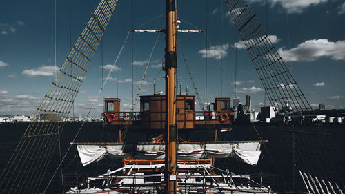 Sailboats moored in sea against sky