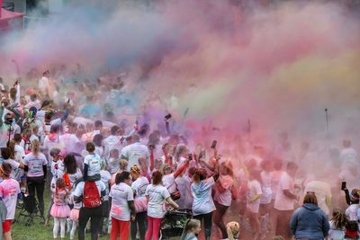 Crowd enjoying in traditional clothing against sky