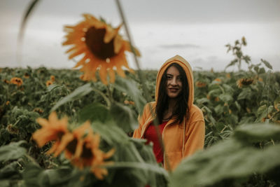 Young woman standing at sunflower farm