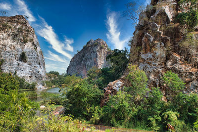 Panoramic view of rocks and trees against sky