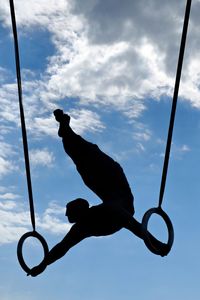 Low angle view of silhouette sculpture against sky