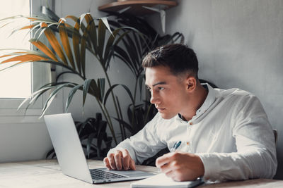 Young man using laptop at home