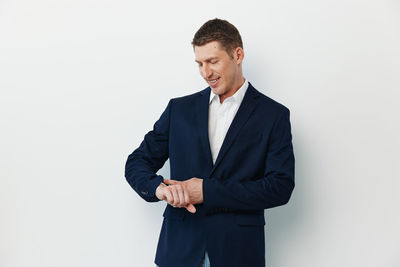 Portrait of businessman standing against white background