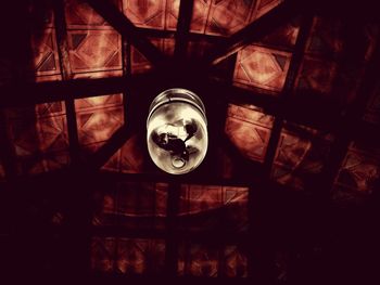 Low angle view of illuminated lighting equipment hanging on ceiling