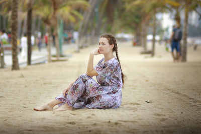 Young woman sitting at beach
