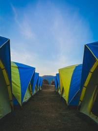 Multi colored tent camping against blue sky