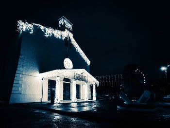 Illuminated traditional building against sky at night