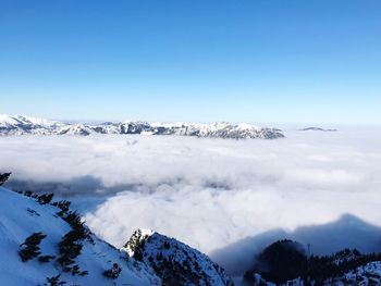 Scenic view of snowcapped mountain against blue sky