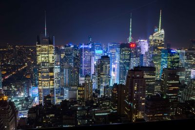 Aerial view of city lit up at night