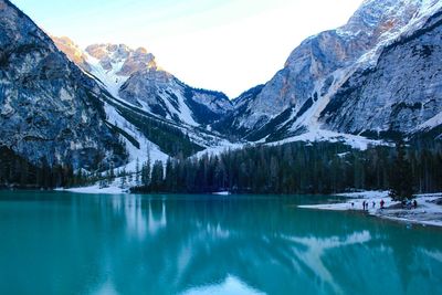 Scenic view of lake and snowcapped mountains against sky