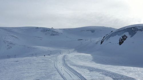 Scenic view of snow covered mountains against sky