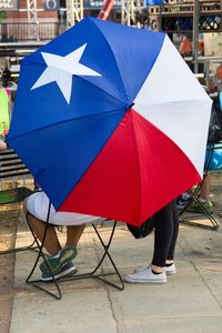 Low section of people with umbrella