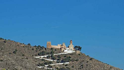 Low angle view of old ruins against blue sky