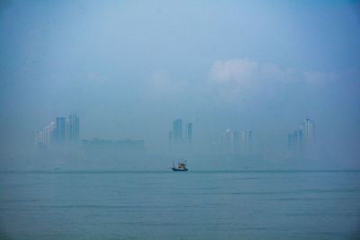 Boat sailing in sea against sky