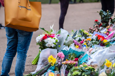 Low section of people standing by flower shop