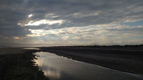 Scenic view of sea against cloudy sky